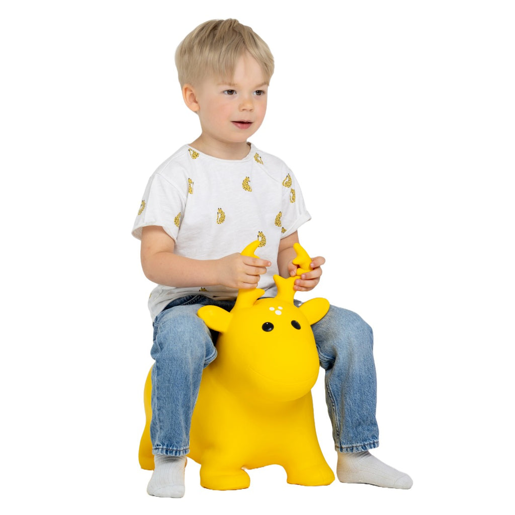 bold yellow moose hopper toy for kids bouncing confidently on a bright sunny day