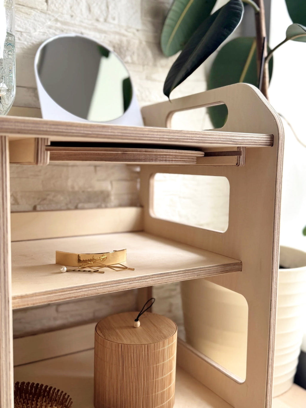 a toddler's wooden washbasin with a removable enamel bowl, shown in soft morning light on a patio