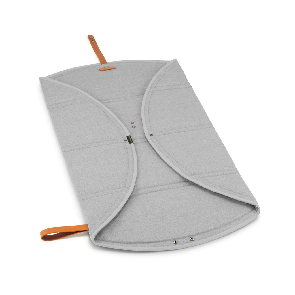 soft grey okka travel mat for dogs folded neatly on a cozy blanket