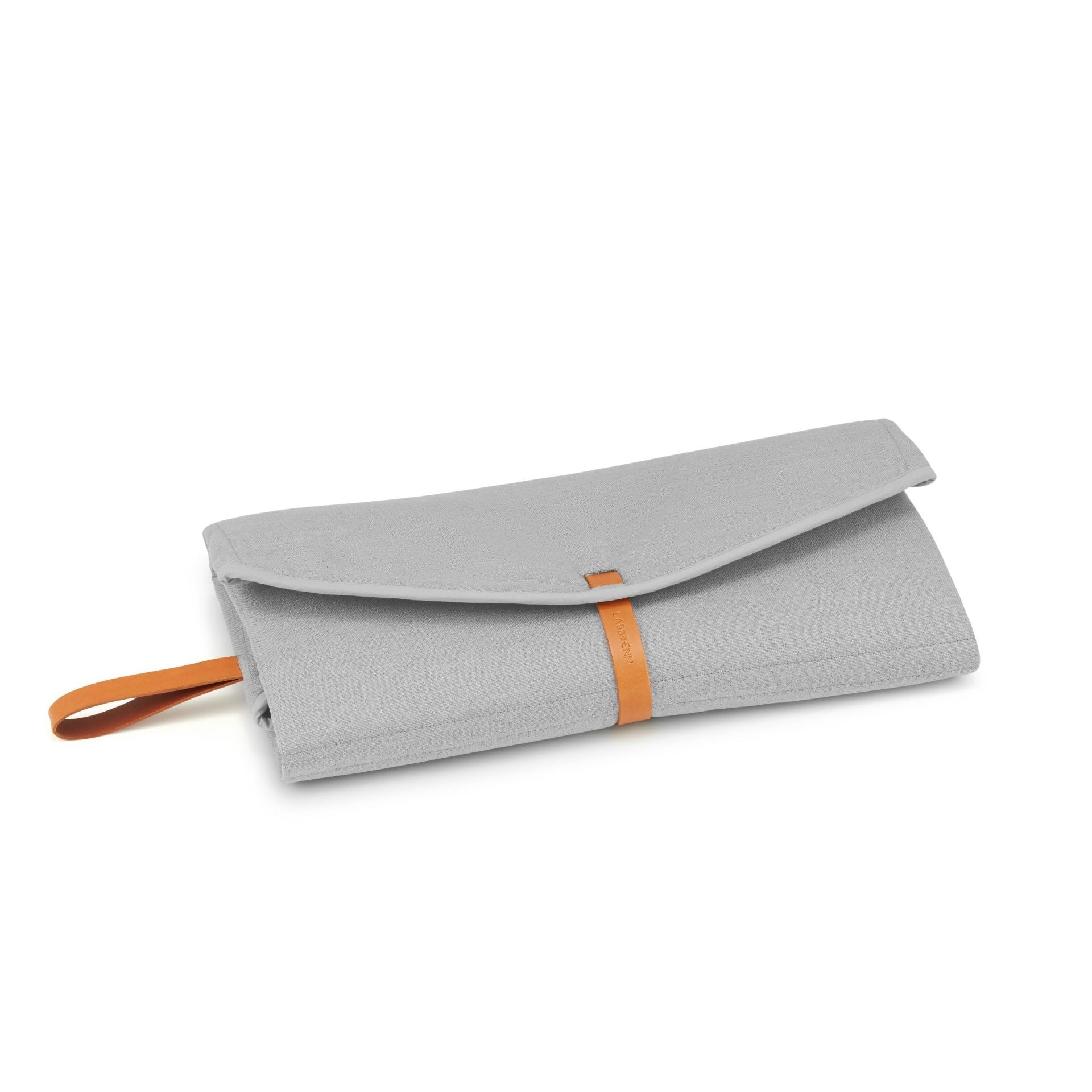 elegant grey okka travel mat with sophisticated leather accents laid out on a park bench