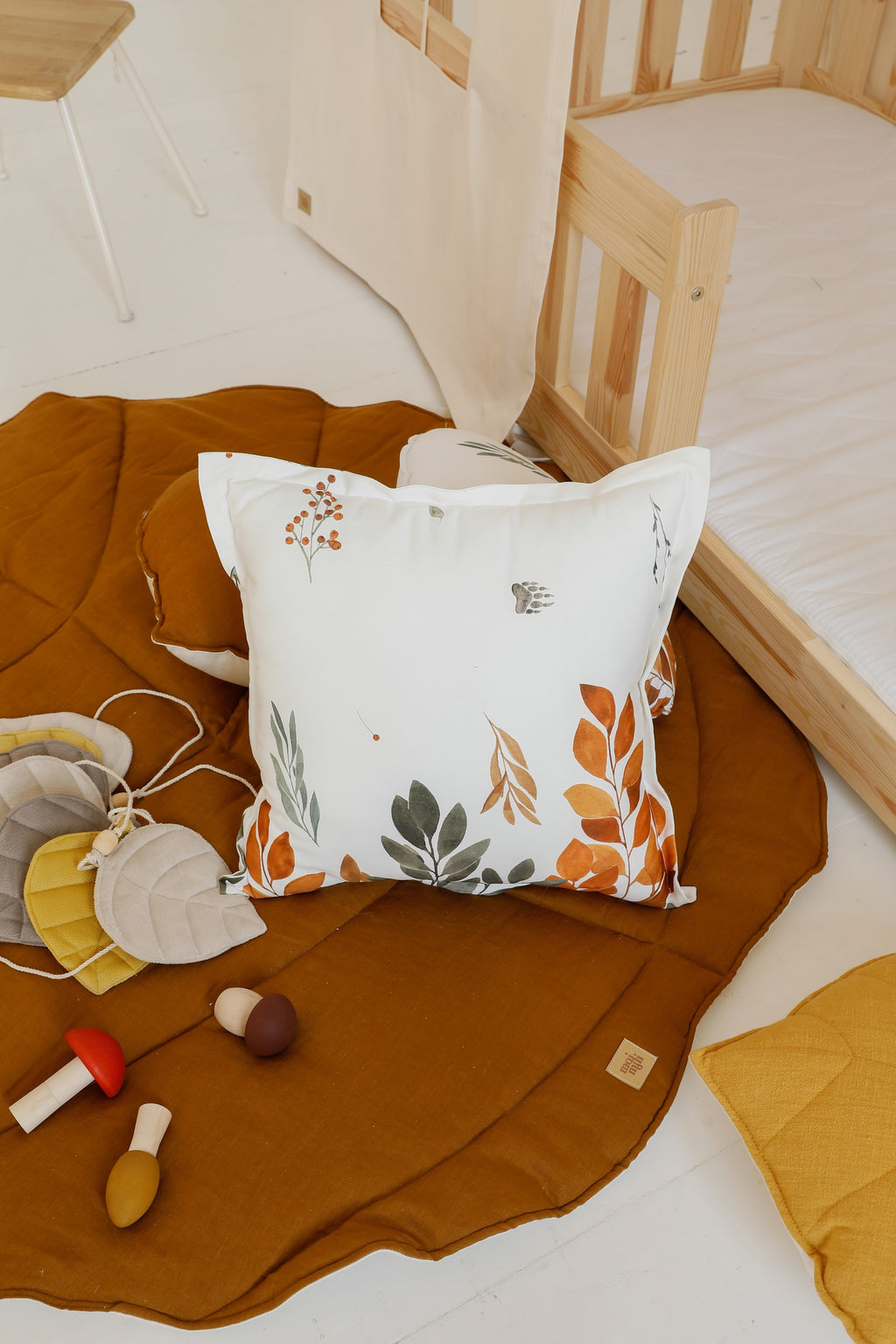 handmade caramel leaf playmat in a cozy nursery corner with soft morning light