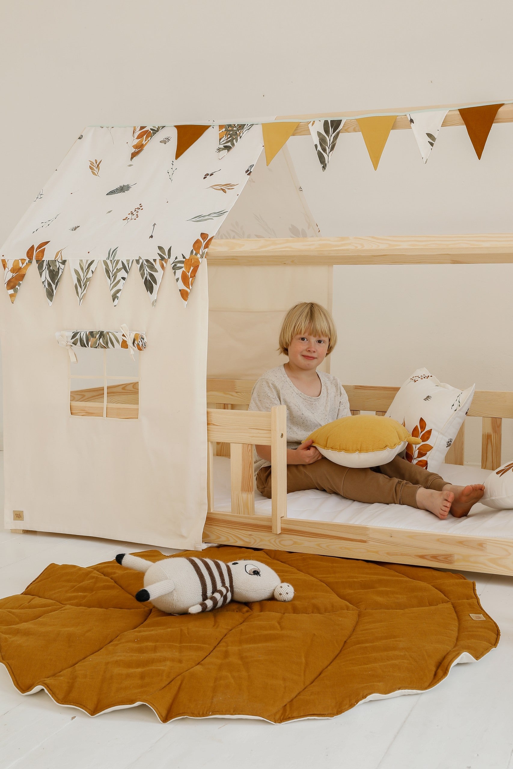 bold caramel leaf playmat on a dark floor - a statement piece for modern nurseries