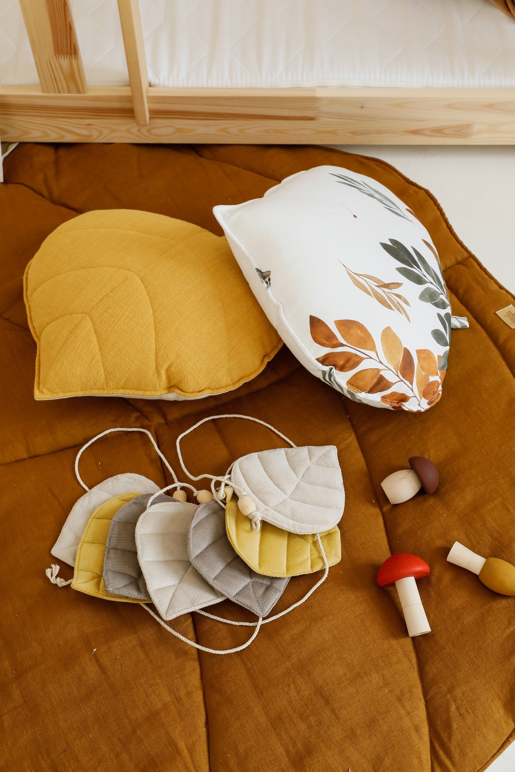 handcrafted caramel leaf playmat on a wooden floor in warm afternoon light