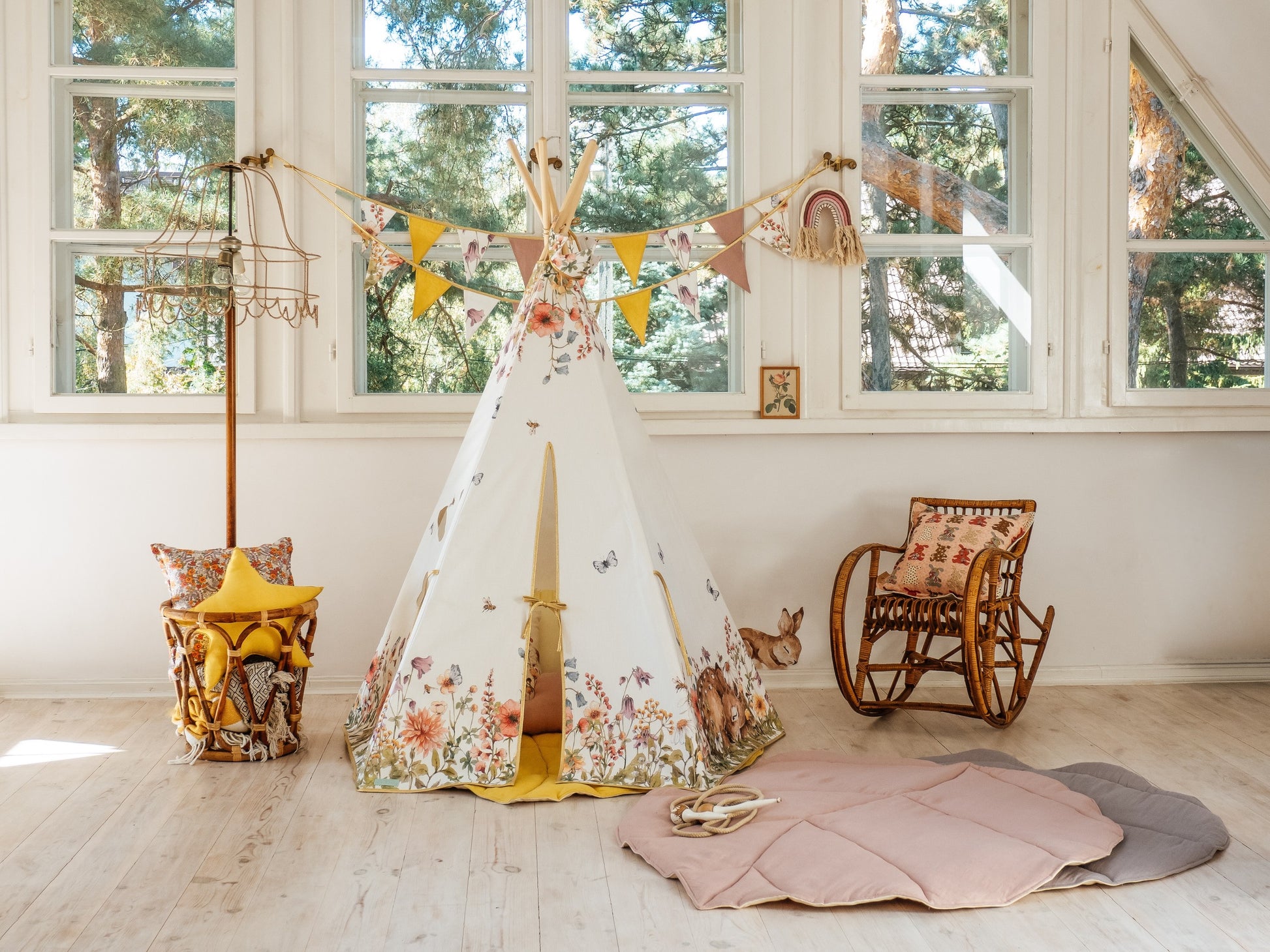 a soft pink organic leaf playmat on a cozy nursery floor, inviting gentle play and quiet moments