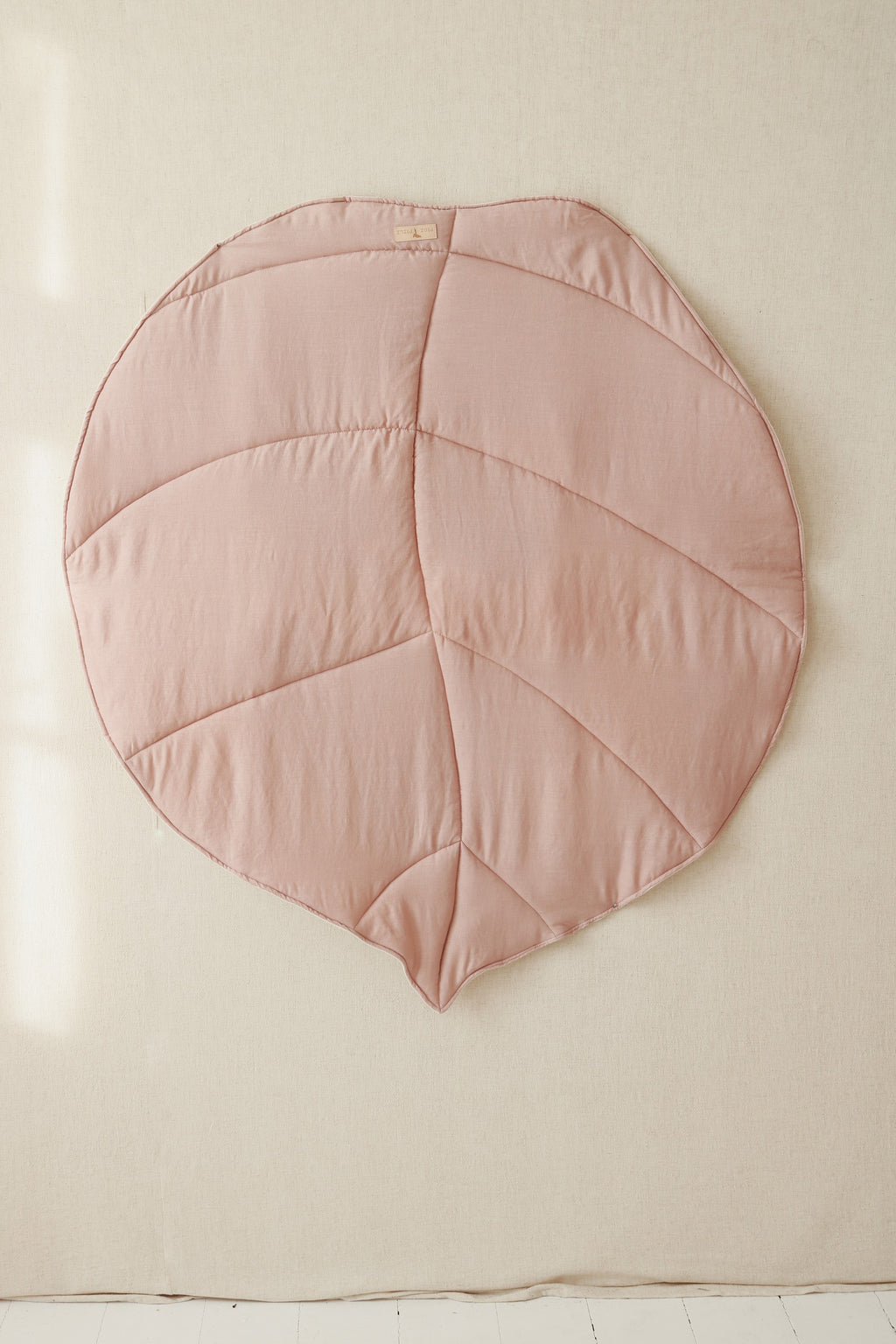 powder pink leaf playmat in a cozy nursery corner with soft morning light