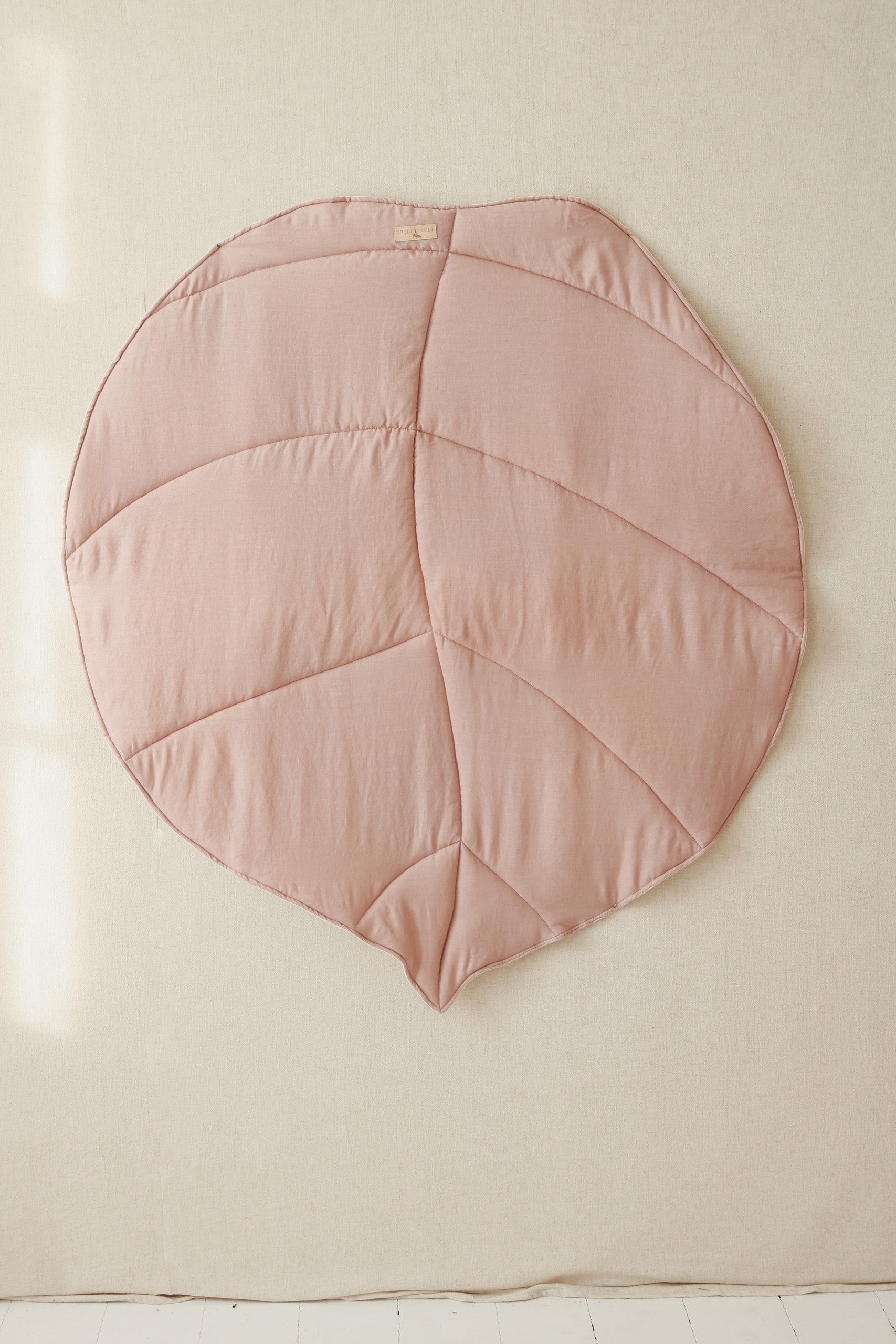 powder pink leaf playmat in a cozy nursery corner with soft morning light