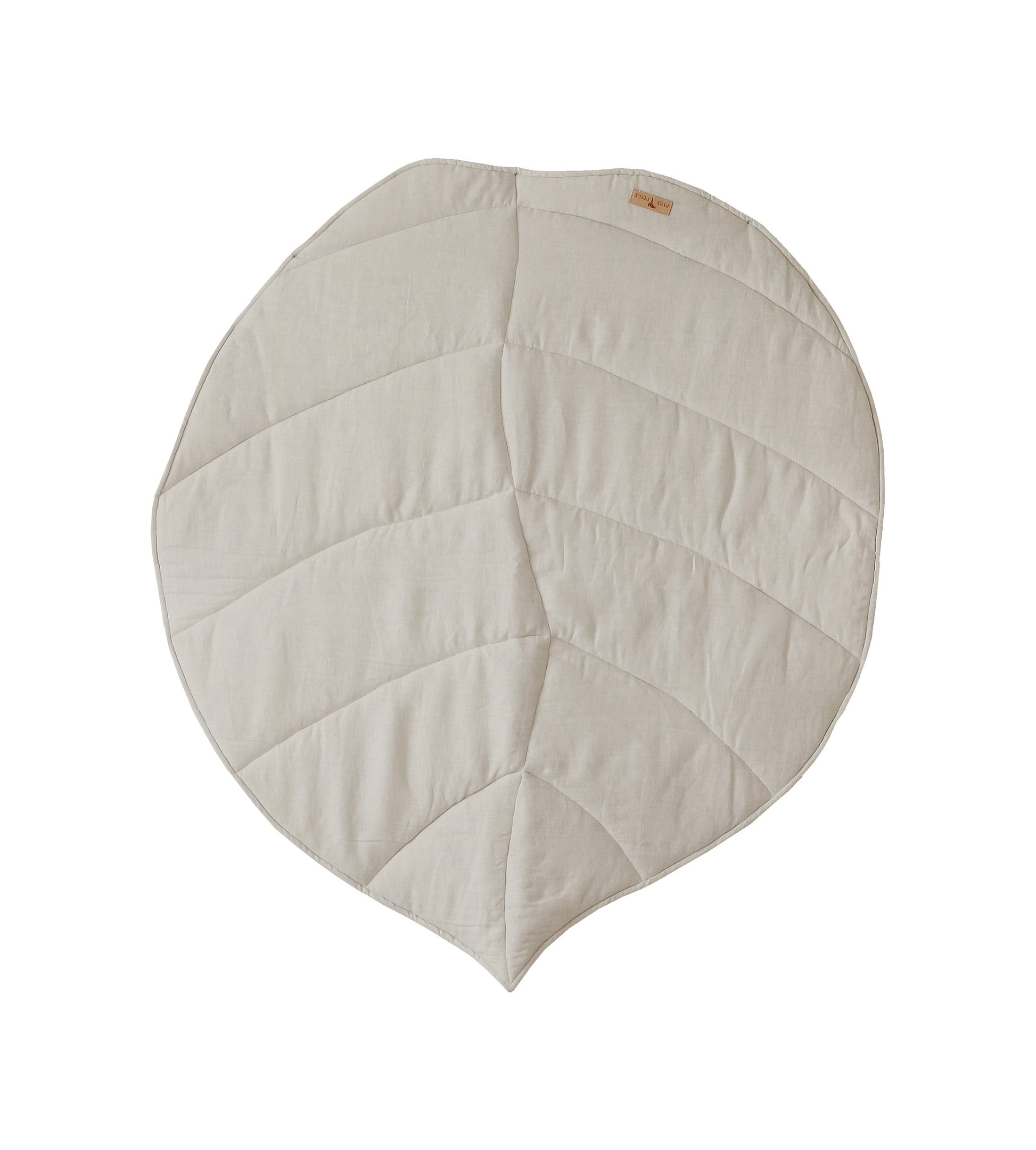 soft sand-colored ginkgo leaf playmat on a nursery floor in gentle morning light