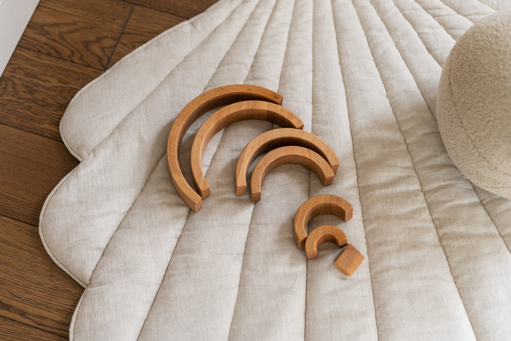 soft sand-colored ginkgo leaf playmat on a cozy nursery floor, inviting quiet play