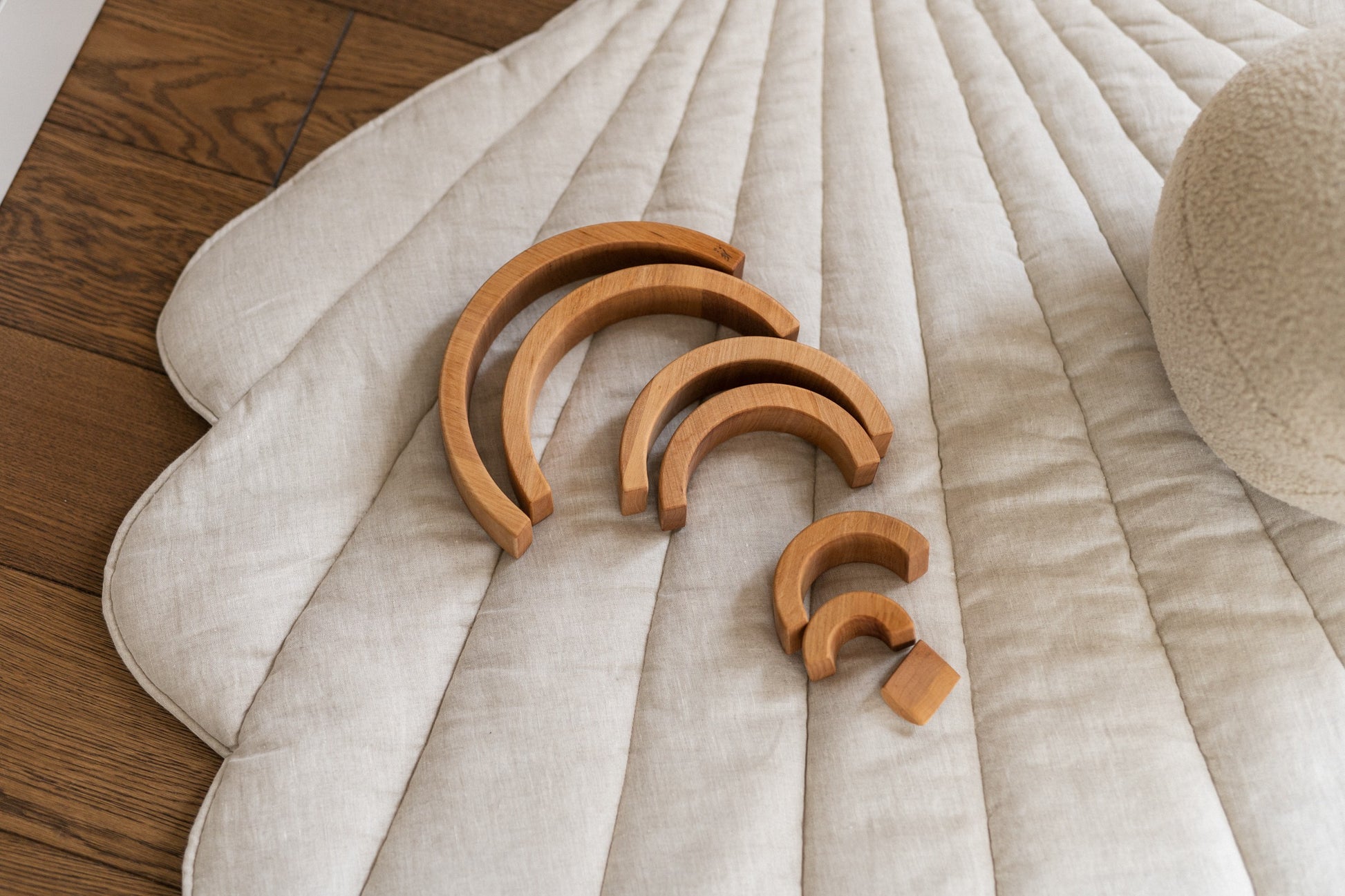 soft sand-colored ginkgo leaf playmat on a cozy nursery floor, inviting quiet play