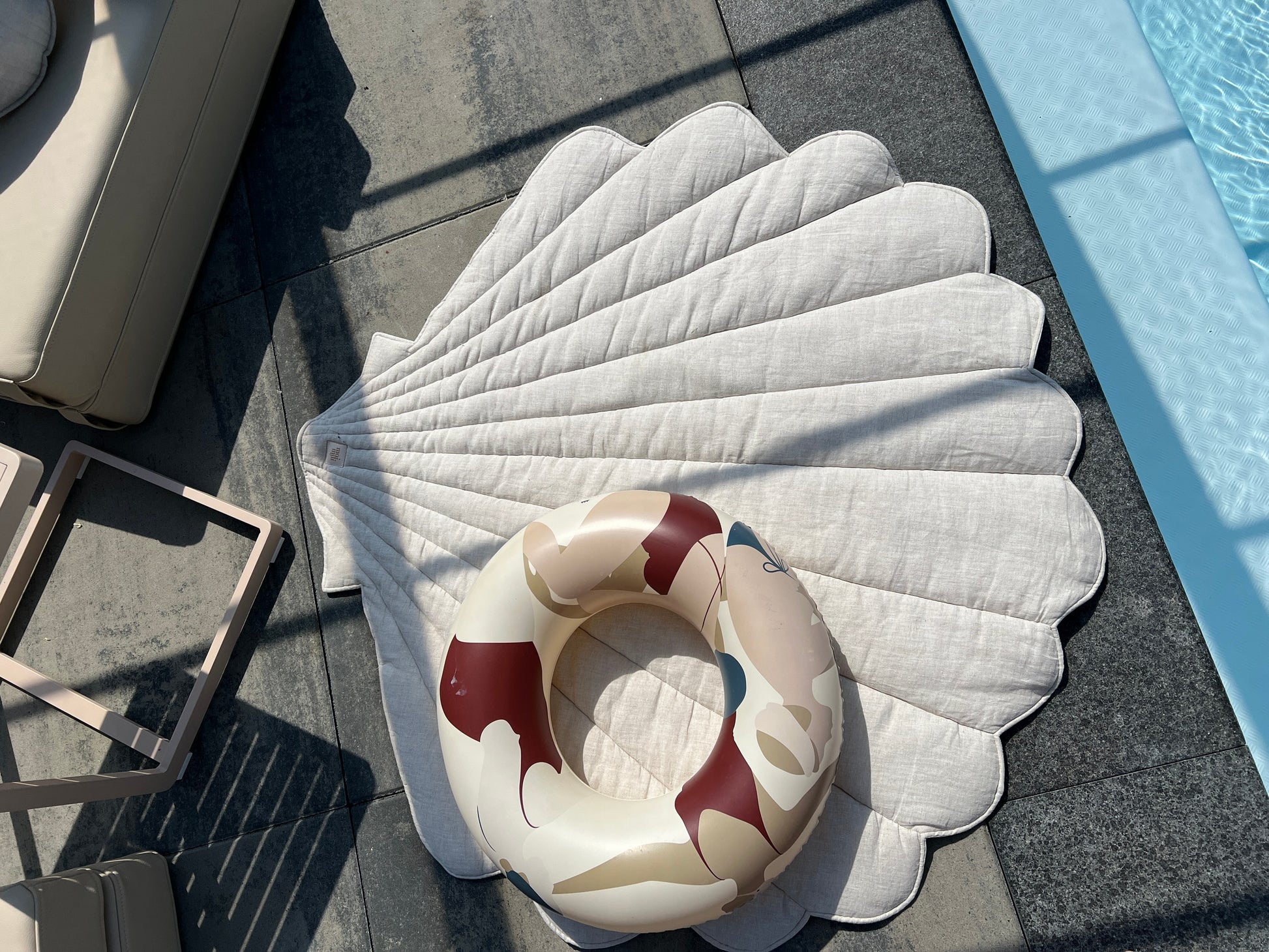 handmade ginkgo leaf playmat on a sandy beach, perfect for a child's seaside picnic