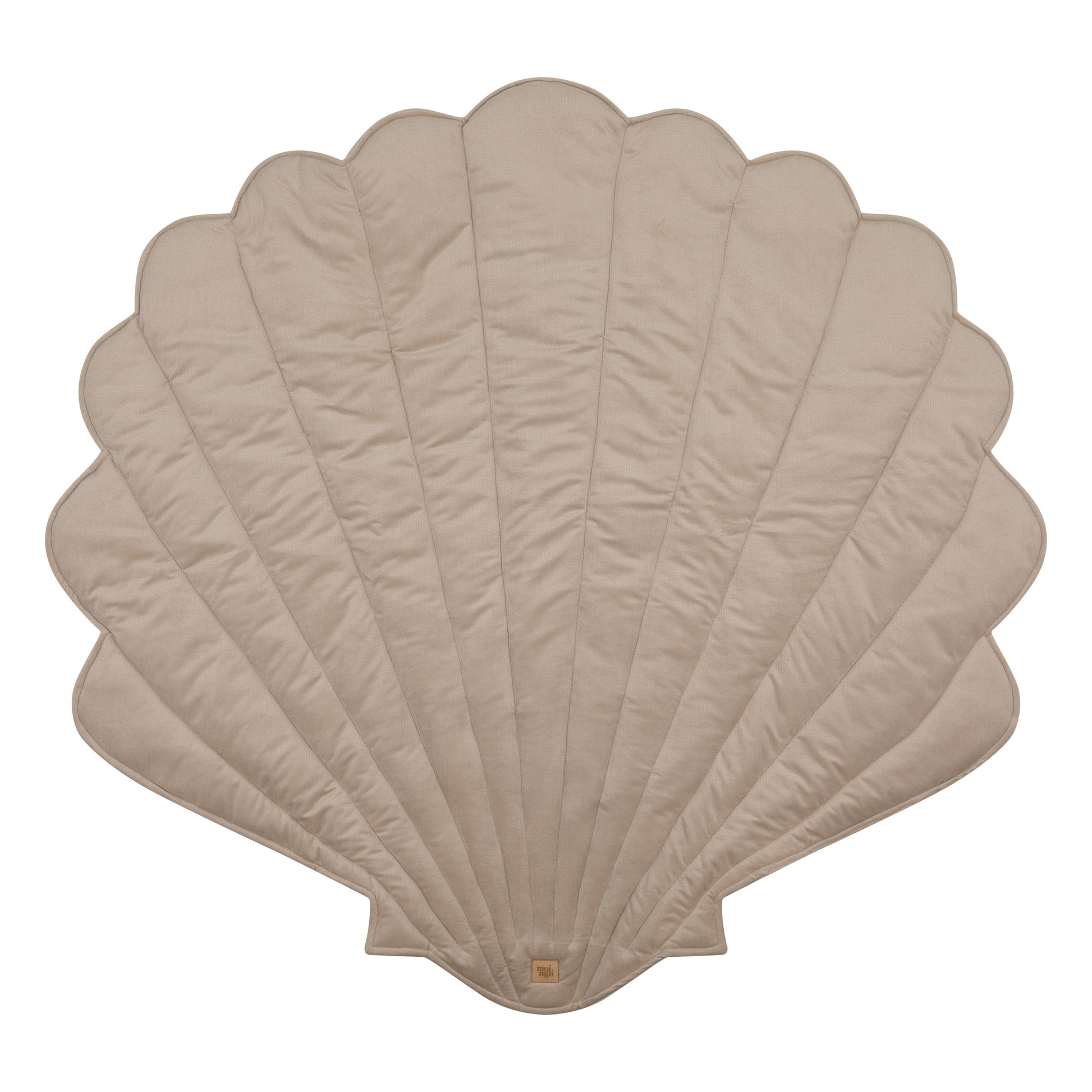 close-up of a toddler's hand playing on the soft beige ginkgo leaf playmat