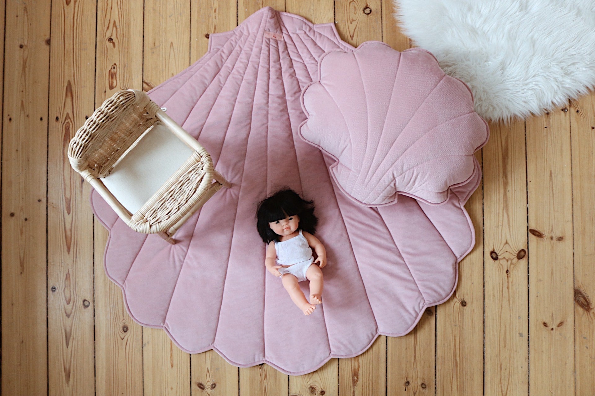powder pink ginkgo leaf playmat spread on grass under sunlight, perfect for picnics or toddler playtime