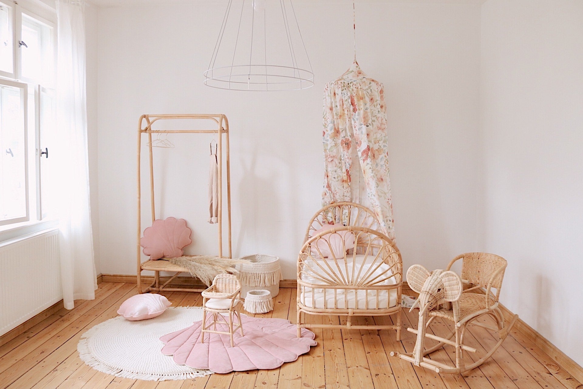 elegant powder pink ginkgo leaf playmat on a wooden floor, soft velvet side up, natural light highlighting its texture