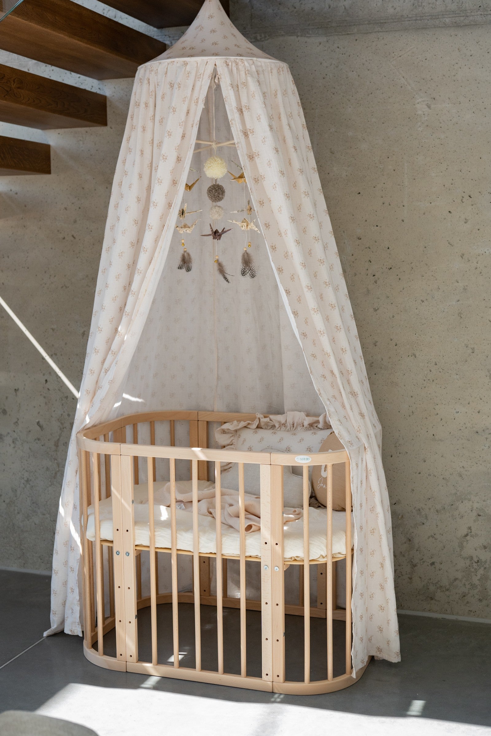 organic cotton boho flower canopy hung over a bed with soft mint fabric draping naturally