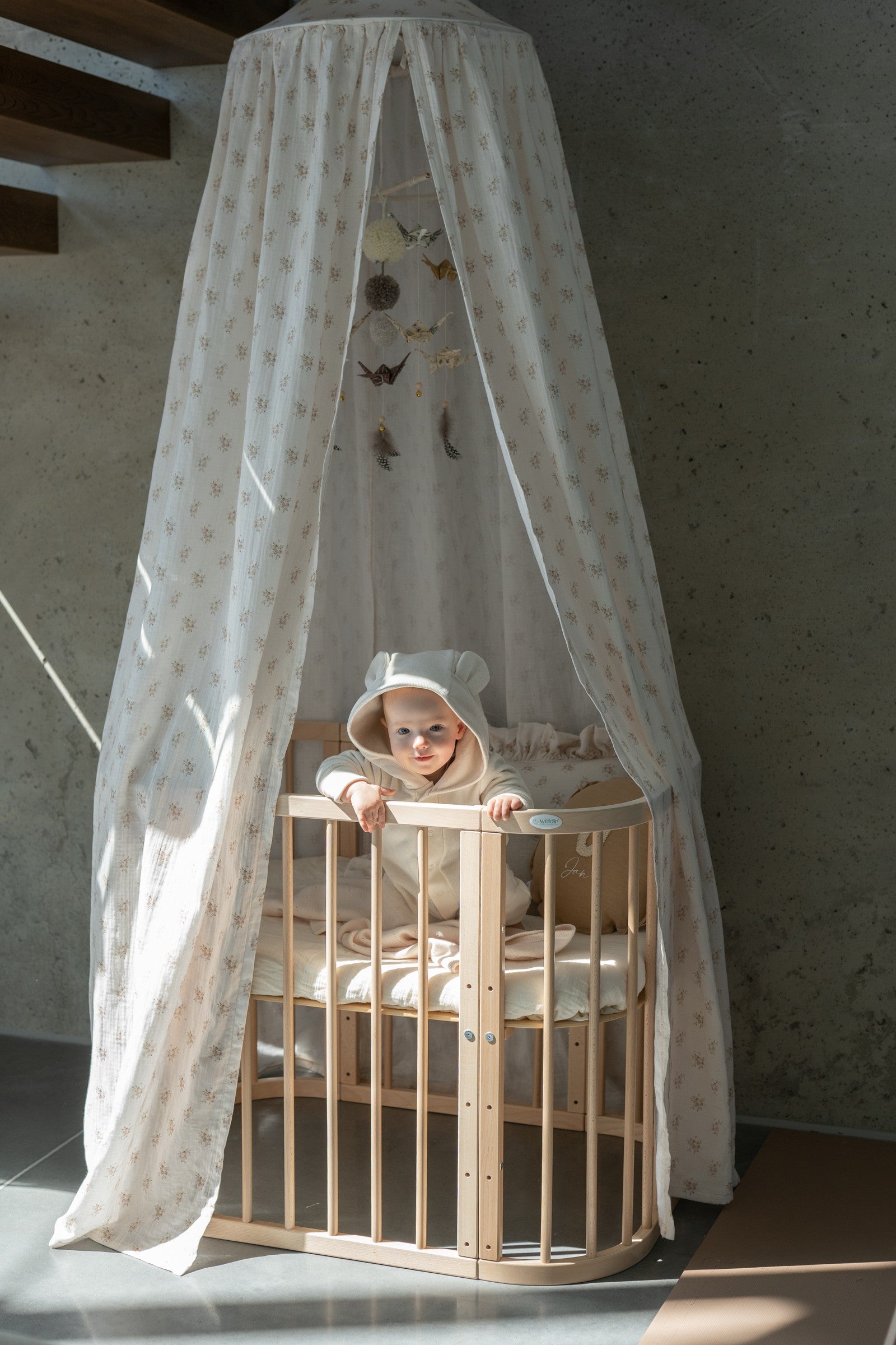 bold boho flower cotton canopy hanging over a cozy bed with warm sunlight streaming through