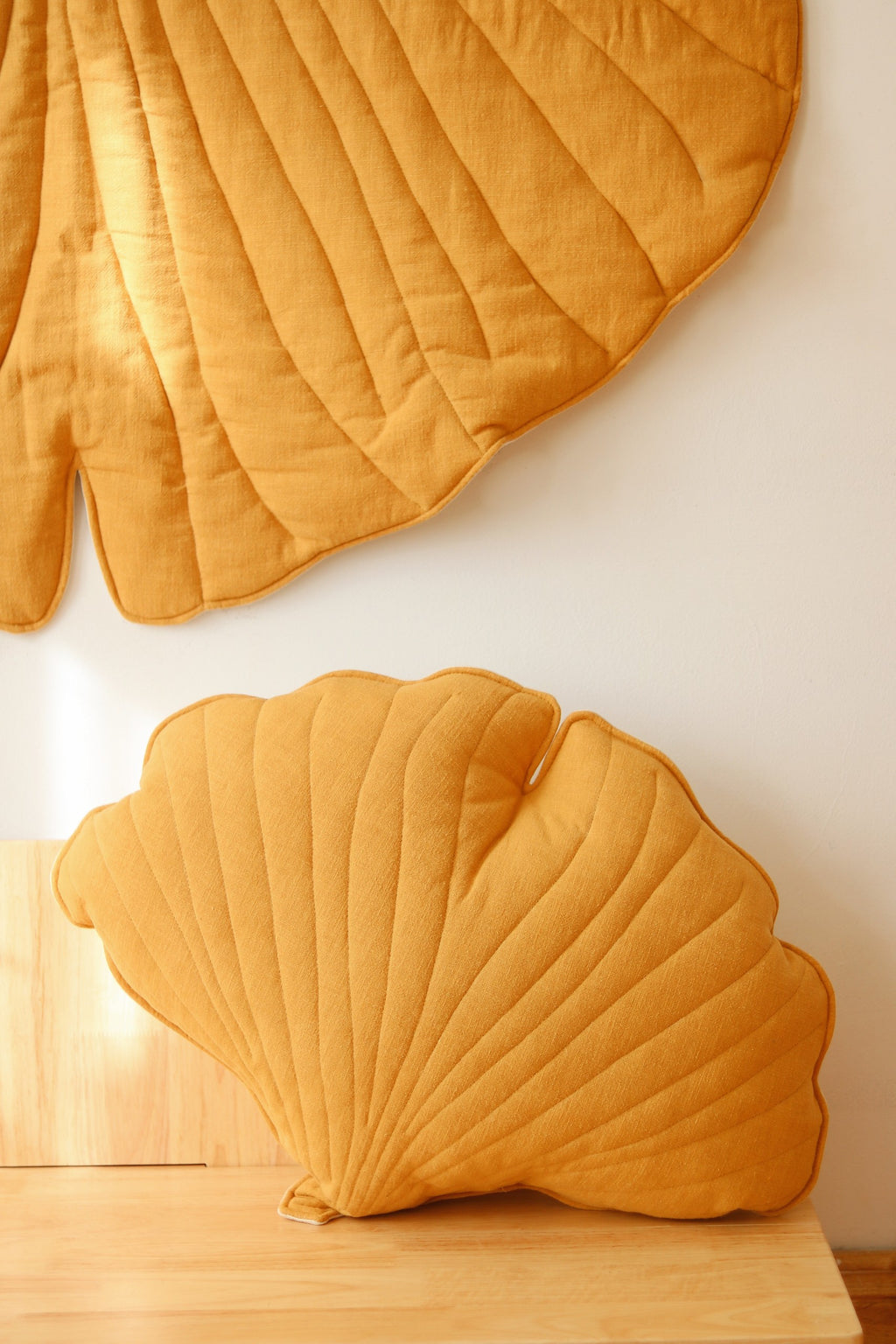 soft mango ginkgo leaf playmat on a nursery floor in gentle morning light