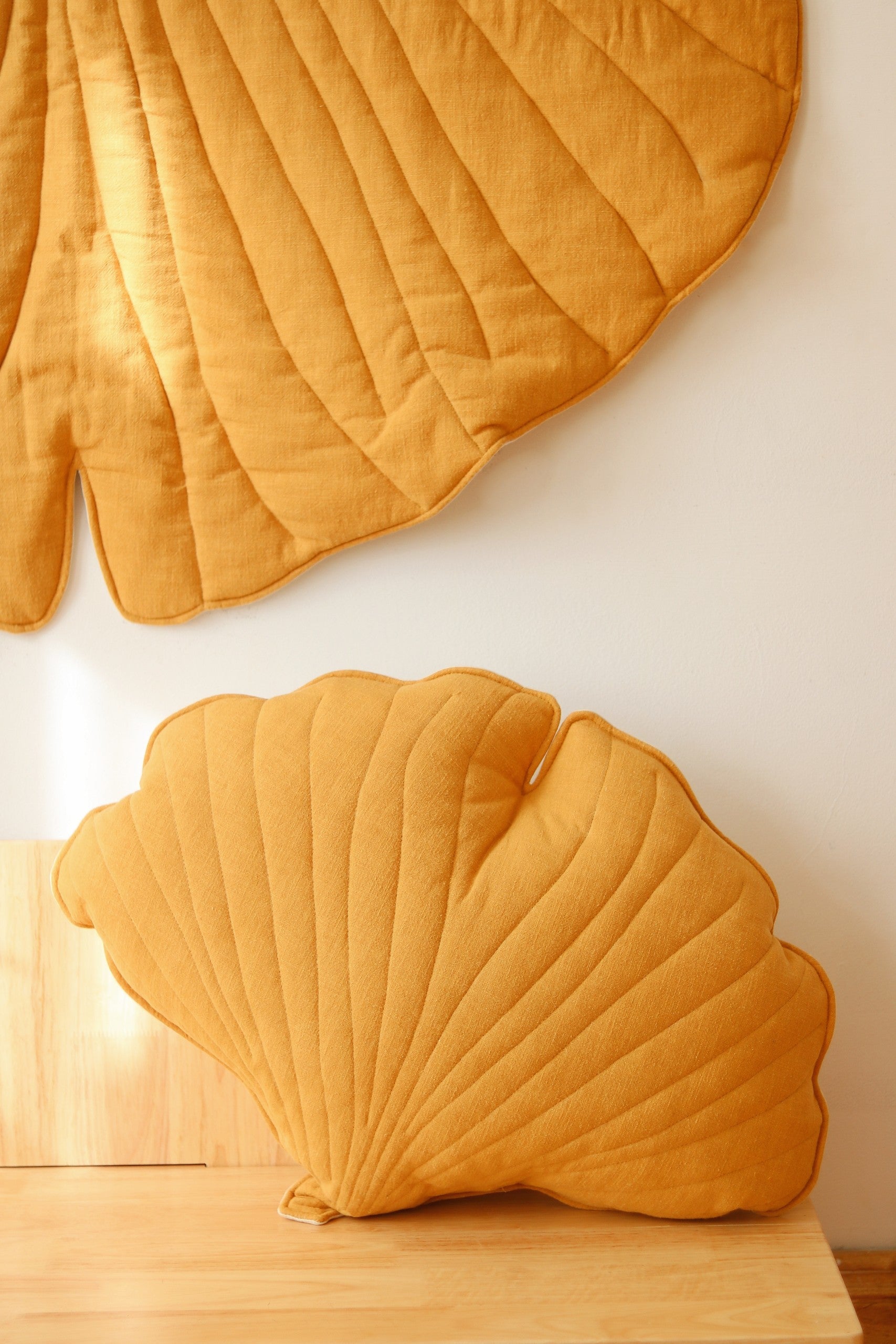 soft mango ginkgo leaf playmat on a nursery floor in gentle morning light