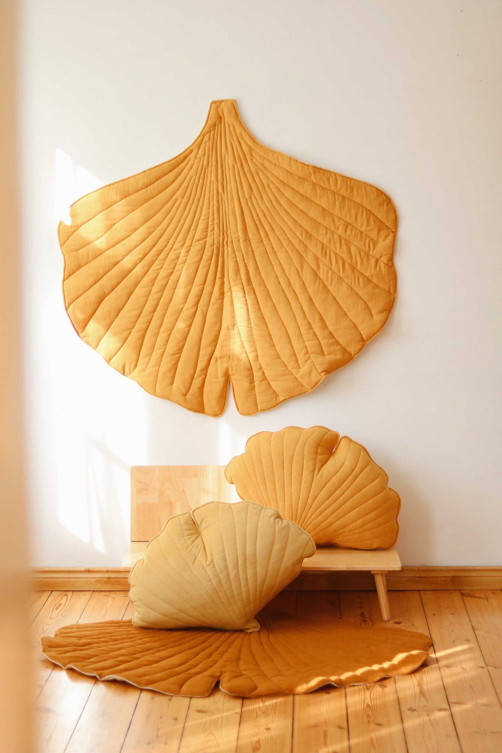 bold mango ginkgo leaf playmat on a bright background, showcasing its vibrant color and artisan texture