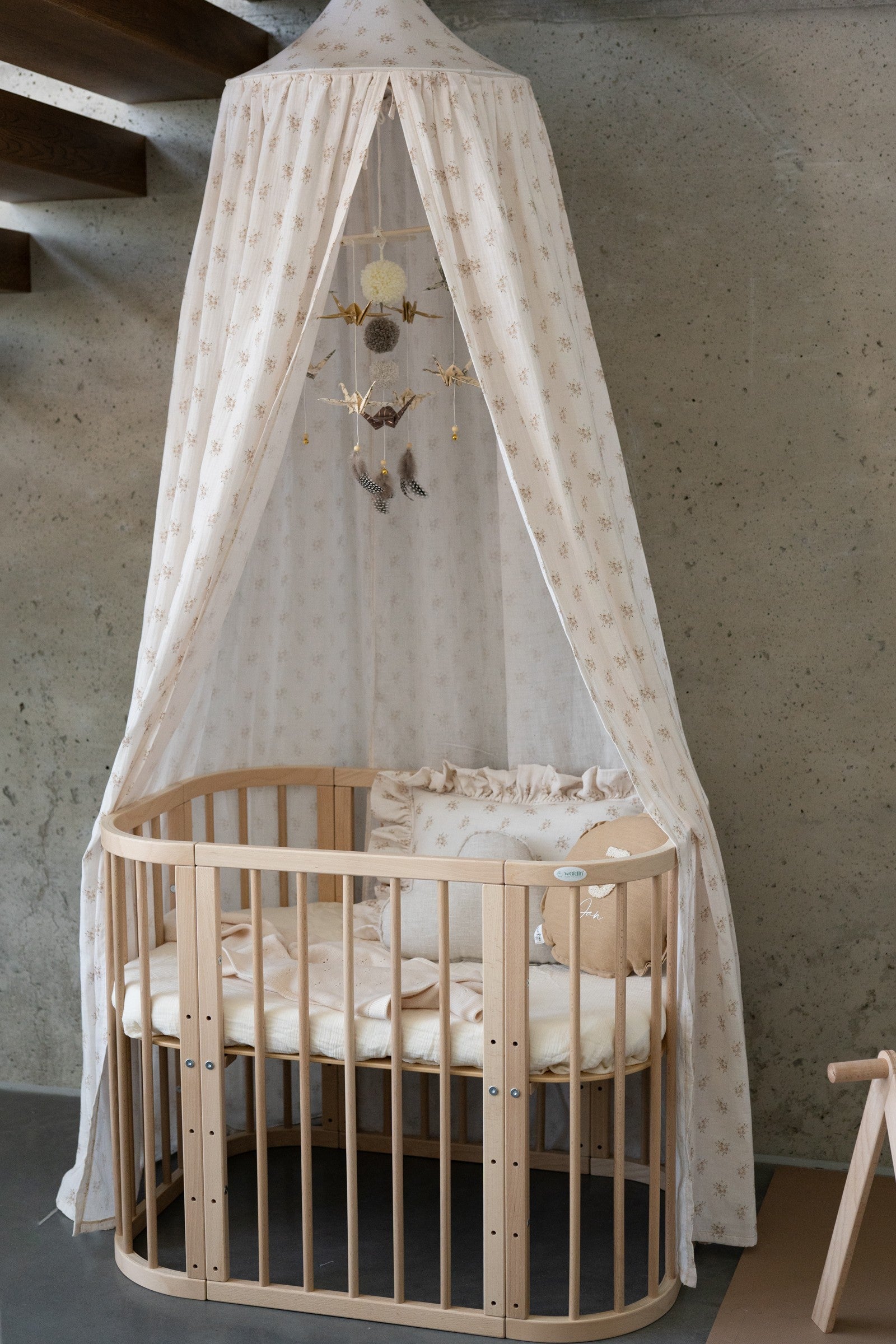 gold dust origami nursery mobile with delicate paper cranes and yarn pompoms, softly spinning in warm sunlight