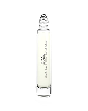 a soft-focus close-up of the ego rex perfume oil bottle resting on a cozy linen textile