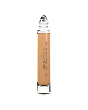 close-up of spring of youth perfume oil bottle with soft morning light highlighting its warm vanilla and cherry scent