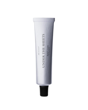 bold close-up of under the sheets hand cream tube with warm saffron and tobacco scent