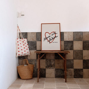 vita felice poster in warm morning light on a cozy rustic wall