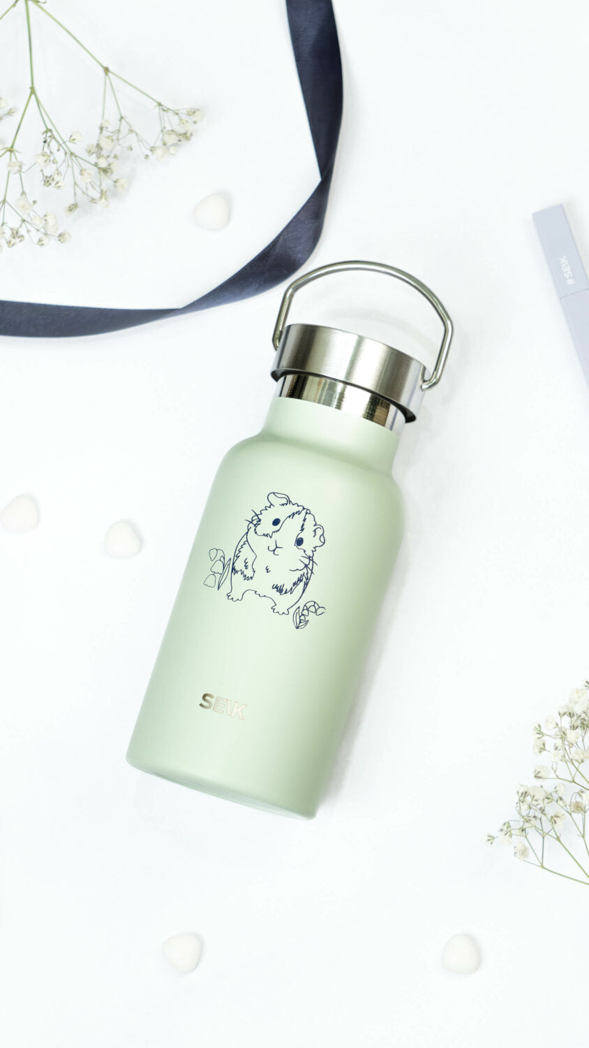 playful guinea pig thermos held by someone on a sunny park adventure