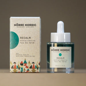 close-up of recalm face oil serum with golden arctic herbs in a bold, confident display