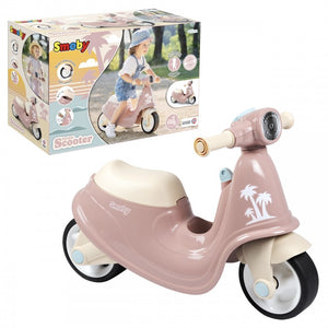 a soft-focus side view of a pink retro scooter for toddlers, bathed in gentle morning light