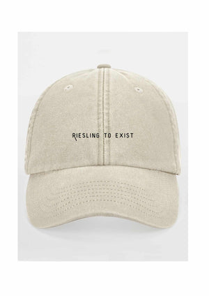 a bold close-up of the riesling to exist cap with sharp embroidery detail