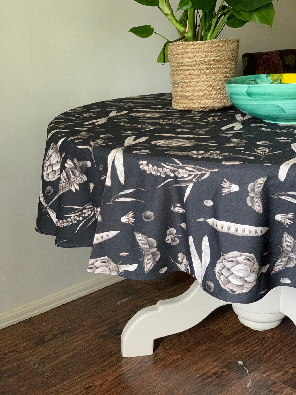 elegant round cotton tablecloth with seeds carbon print laid for a refined dinner party