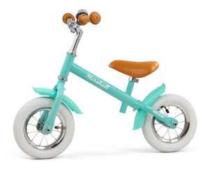 a soft-focus side view of the marshall balance bike with its comfortable saddle and smooth air tires