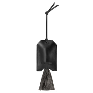 bold black italian leather dog bag dispenser held confidently in hand