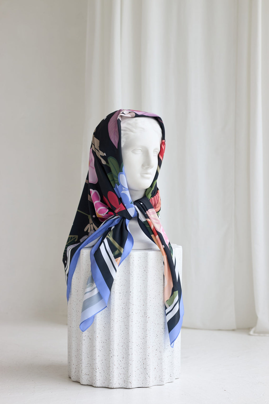 a playful leopard print summer scarf tied in a chic hair wrap with a bright, sunny background