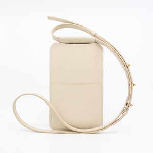 soft beige leather phone bag with a comforting glow, held gently in hand