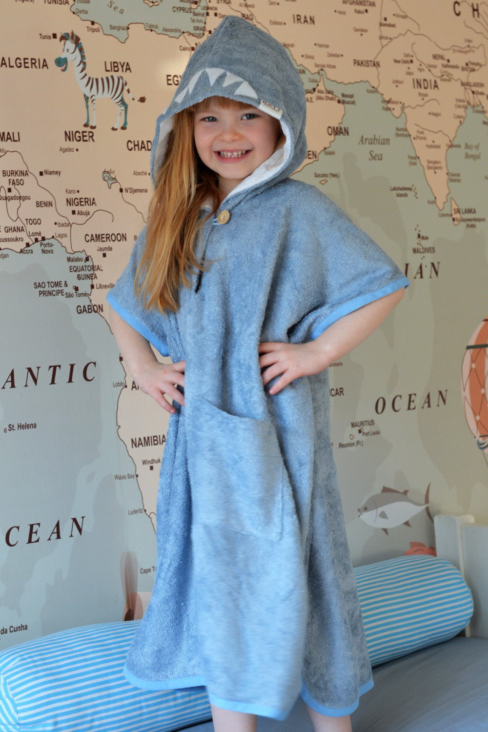 handmade bamboo shark poncho for kids drying off after a splash
