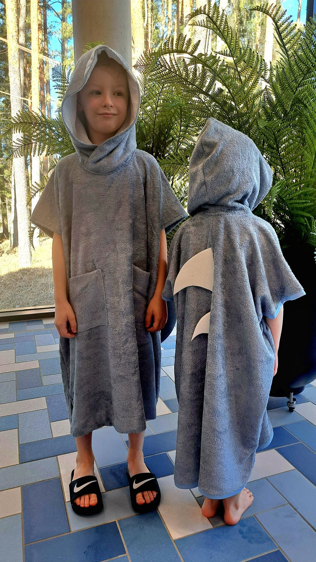 elegant toddler shark poncho in soft bamboo terry, draped beautifully for a refined post-swim look
