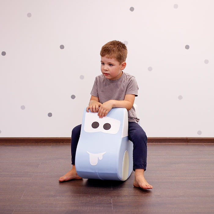 soft light blue ride-on car toy for toddlers, promoting balance and imaginative play in a cozy setting