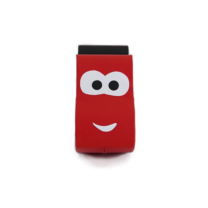 smiling toddler riding a bright red soft play car, giggling as they rock back and forth on a cozy foam seat