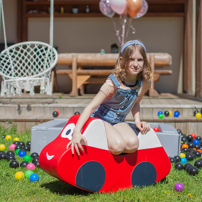 soft red ride-on car for toddlers, cozy and safe, encouraging balance and playful adventures