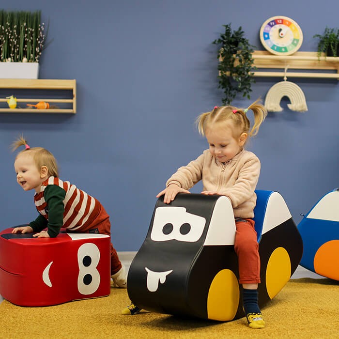 elegant red soft play car ride-on toy for kids, fostering balance and creativity on a sleek foam design