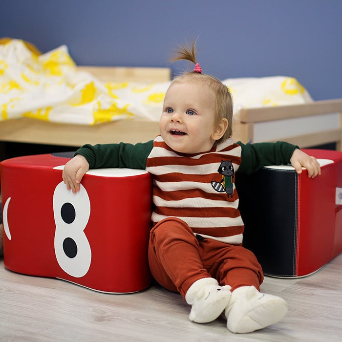 red soft play ride-on car for kids, promoting balance and motor skills with durable eco-leather foam