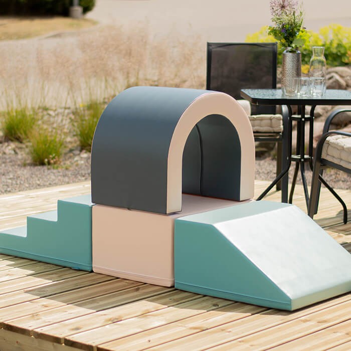 pastel soft play tunnel set with kids crawling through, fostering creativity and social skills