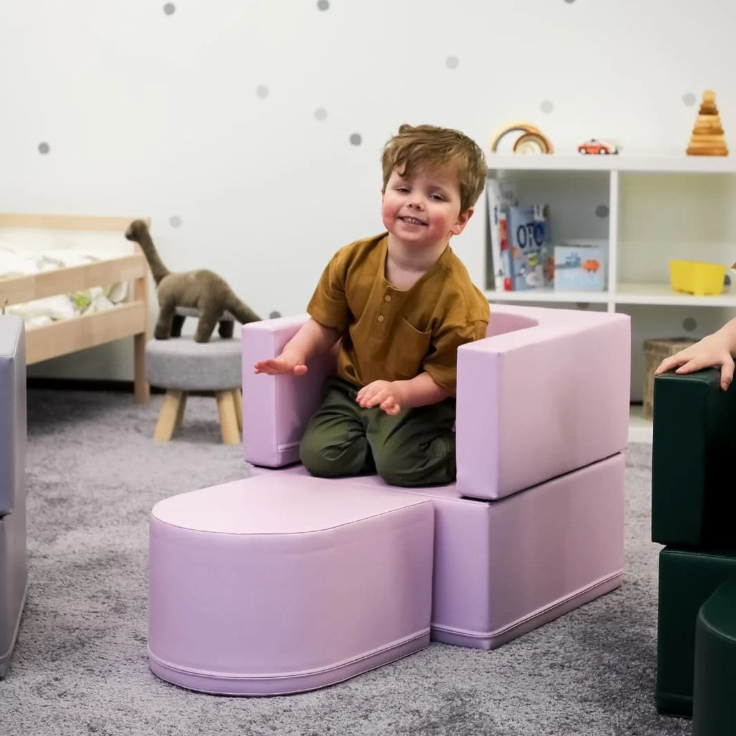 bold pink snoozy kids sofa chair in dramatic front view, ready for playroom adventures