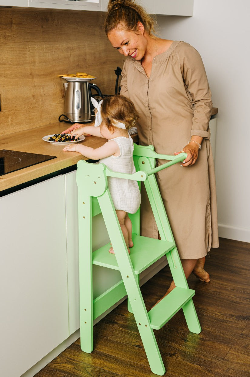 foldable baltic birch step stool for kids folded flat against a wall for compact storage