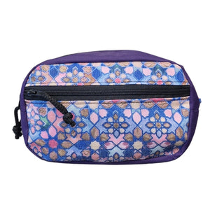 a soft grey water-resistant waist bag held gently in hand, showing its comfortable adjustable strap and modern minimalist design
