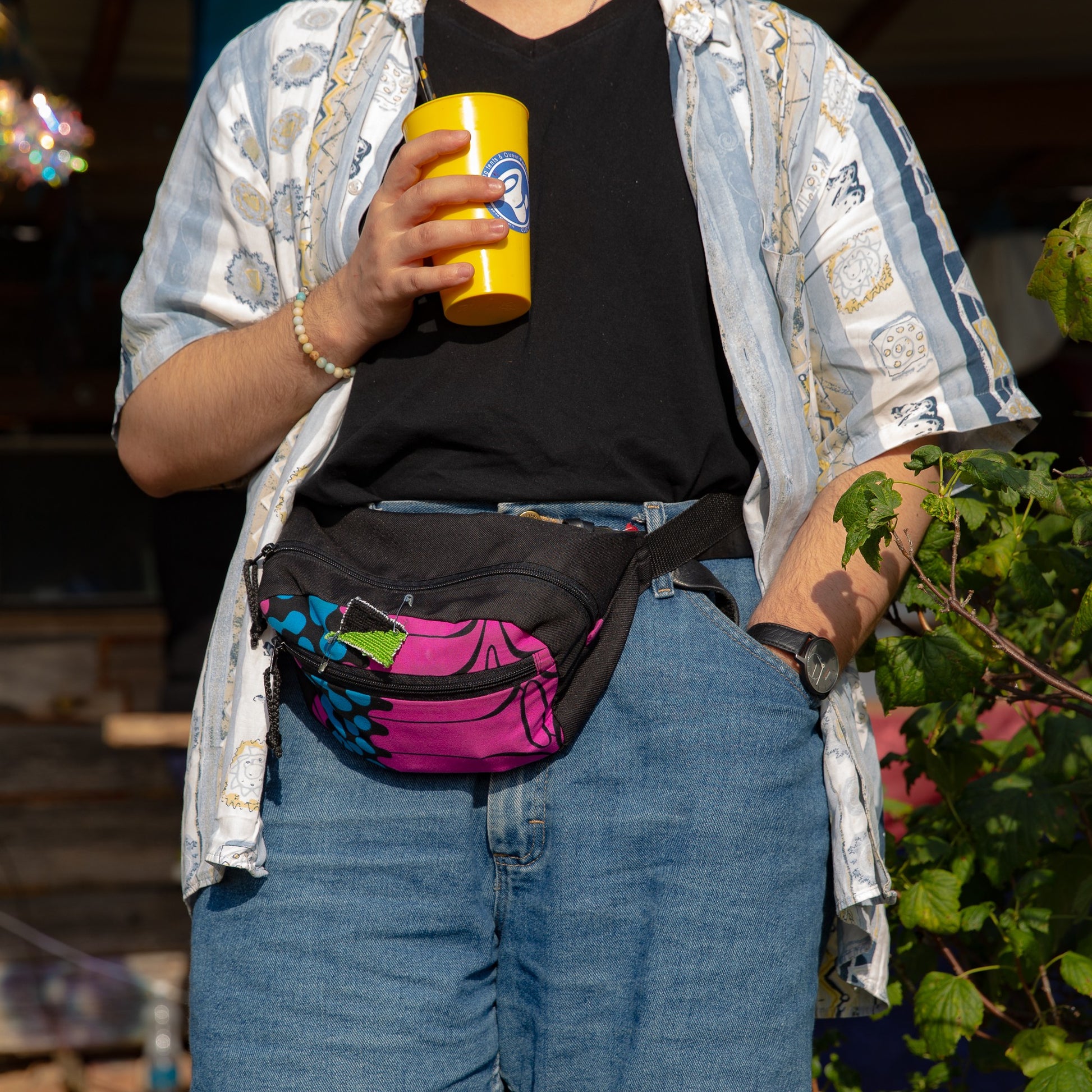 softly lit tropics waist bag with a water bottle in the front pocket, worn comfortably across the chest