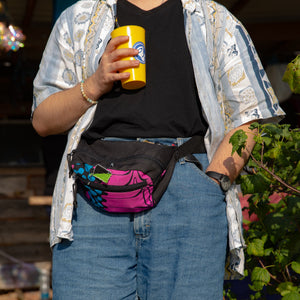 softly lit tropics waist bag with a water bottle in the front pocket, worn comfortably across the chest