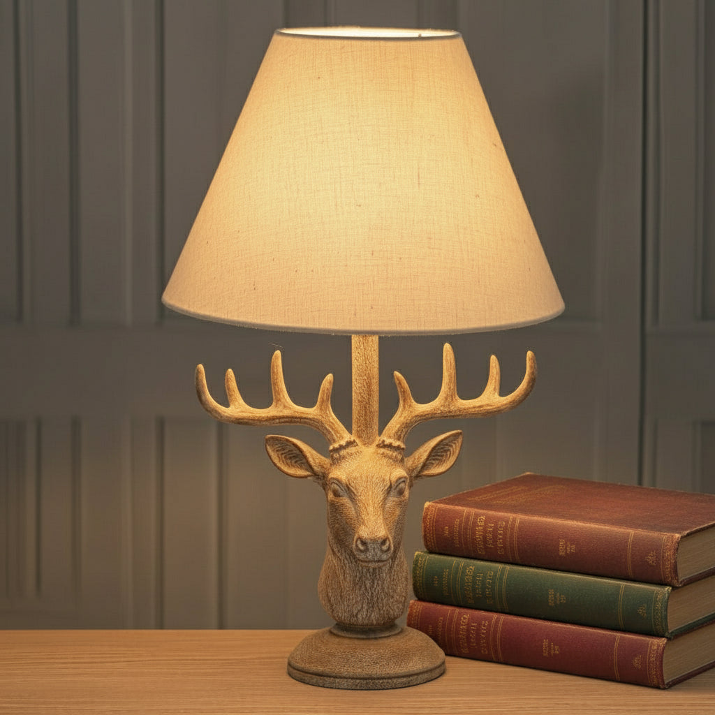 Handcrafted stag head table lamp with stonewashed resin base and natural linen shade in rich brown. by sostter at brixbailey.com